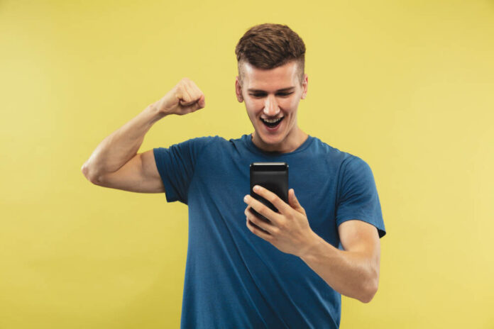Caucasian young man's half-length portrait on yellow background